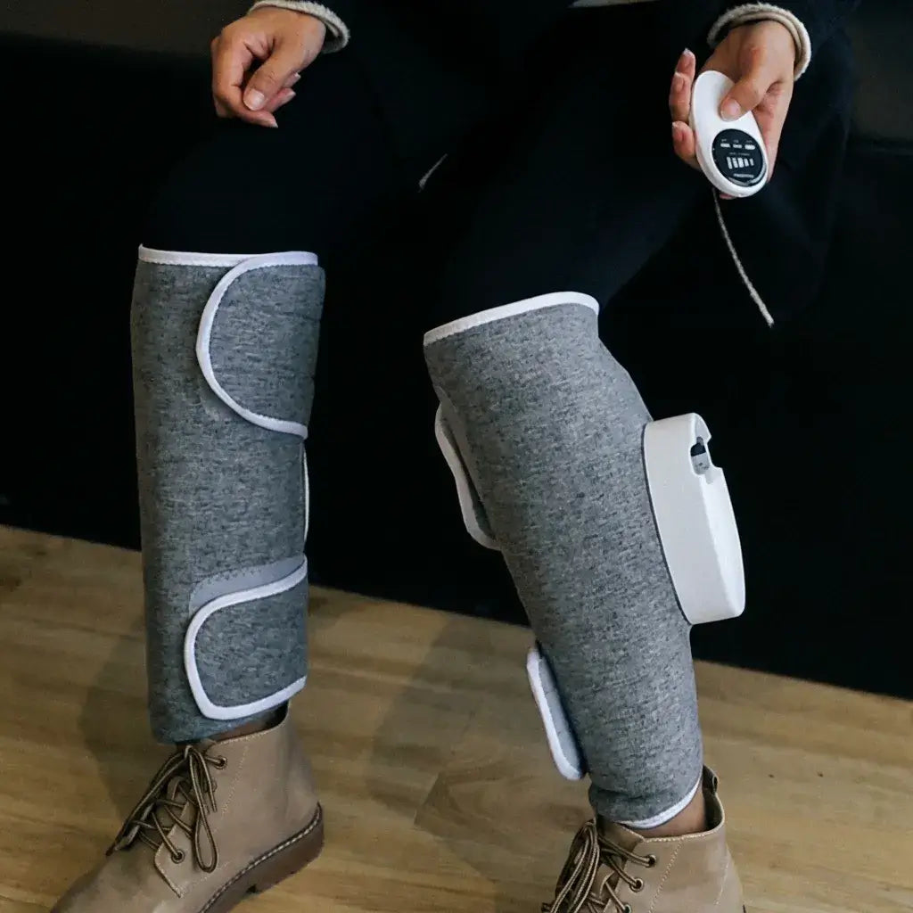Person using the Halipax Calf Massager on their legs, relaxing in a cozy setting.