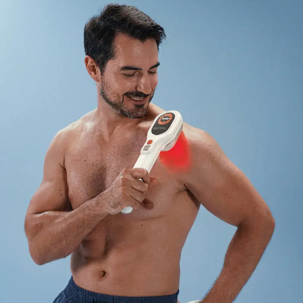 Man using the Dernox Cold Laser Wand on his shoulder, highlighting its handheld design and targeted light therapy.