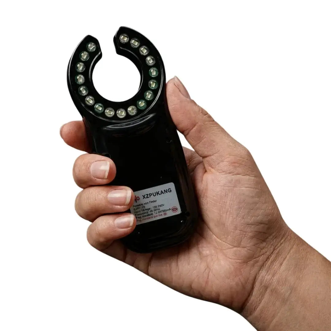 Close-up of a hand holding the VeinHunter Vein Finder, a compact handheld device for vein visibility.