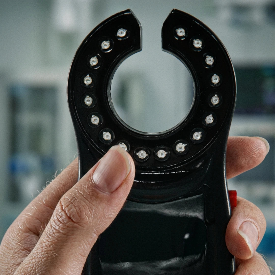 Close-up of the VeinHunter Vein Finder held in hand, showcasing its transillumination technology for vein visibility.