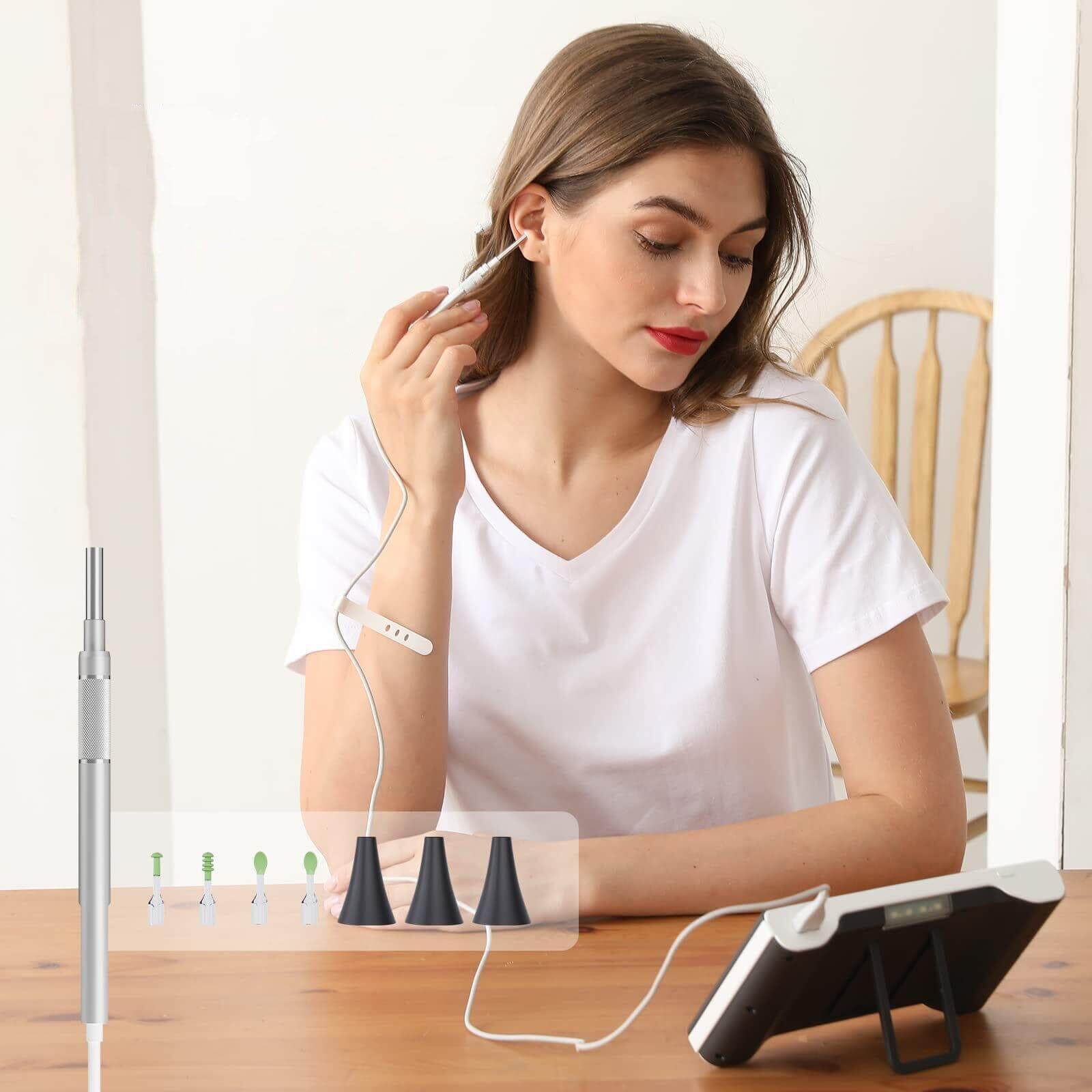 Woman using Halipax HD Digital Otoscope for safe and clear ear cleaning at home with tools and screen.