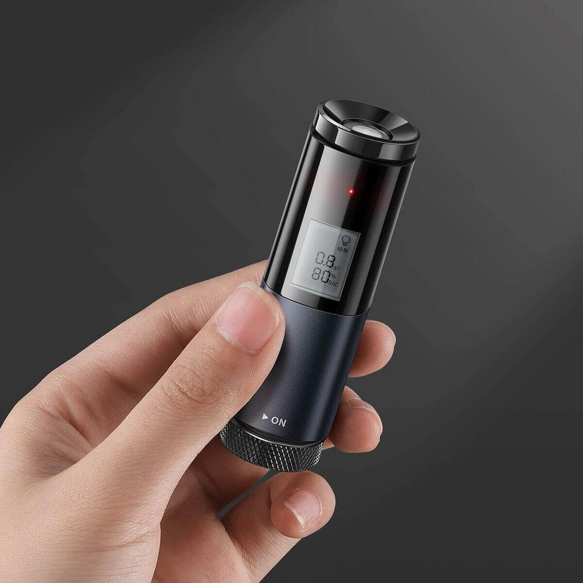 Close-up of a person holding the Halipax-S20 Smart Breathalyzer with a digital display.