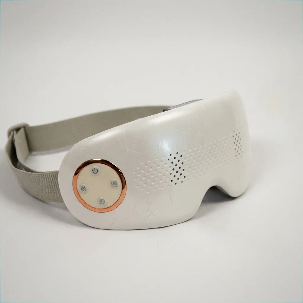 Auri 3D Steam Eye Massager with a sleek design featuring a comfortable strap and soothing vents for relaxation.