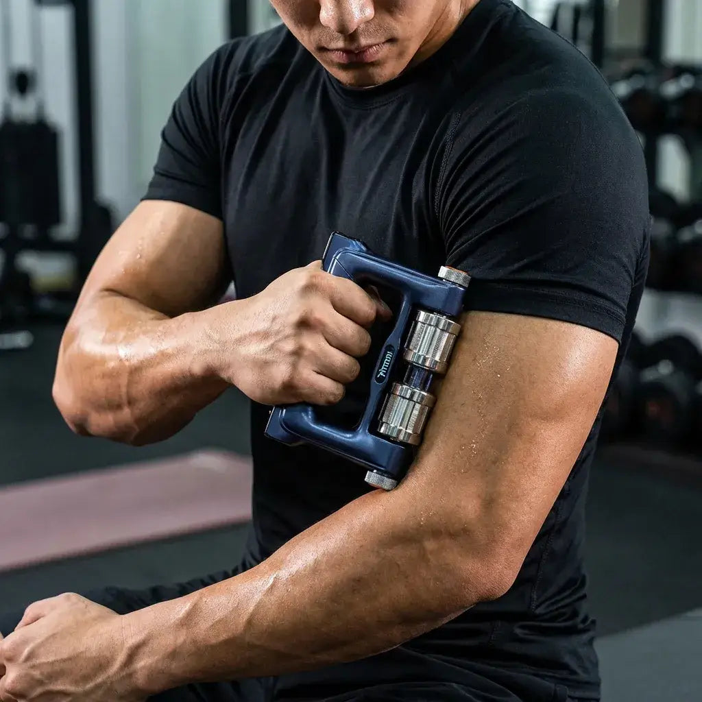 Fitdash Pathfinder Roller being used on the arm for muscle recovery and comfort in a gym setting.