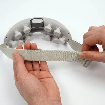 Auri 3D Steam Eye Massager showing adjustable strap and massage nodules on the device.