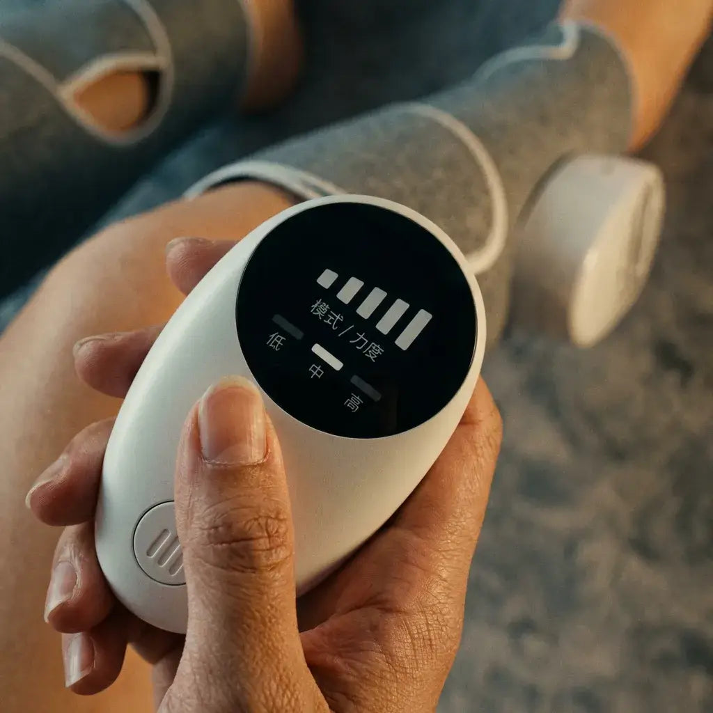 Person holding the control device for the Halipax Calf Massager, showing various intensity levels on the screen.