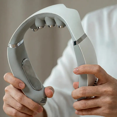 Asmenix Smart Neck Massager held by hands, showcasing its sleek design and massage head features.
