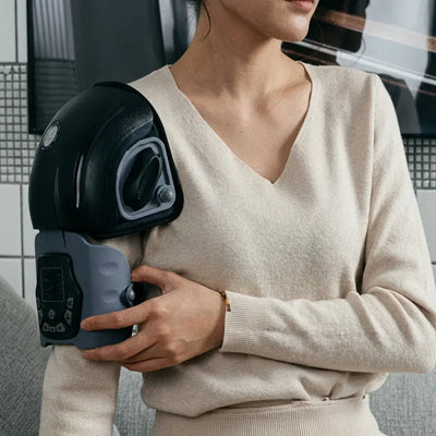 Person using the FlexiTherm Pro Knee Device for soothing knee relief and comfort.