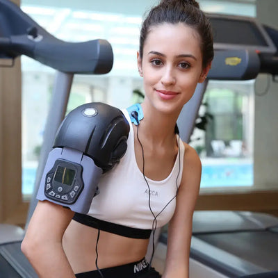 FlexiTherm Pro Knee Device in use by a young woman for knee therapy and comfort at the gym.