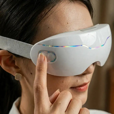 Woman adjusting the control button on Halipax Micro Steam Eye Cover for soothing eye relief.