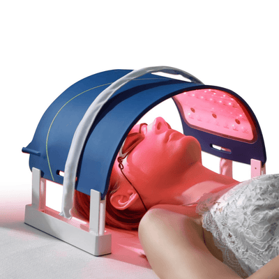 Woman using LumiCura Flexible Light Panel for light therapy session with protective eyewear.