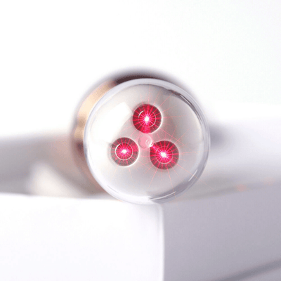 Close-up of the Femniva Wellness Wand showing three red lights on the tip for gentle support.