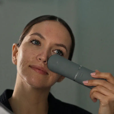 A woman using the Vellura-Gess Contour & Renew device on her face, focusing on daily skincare.