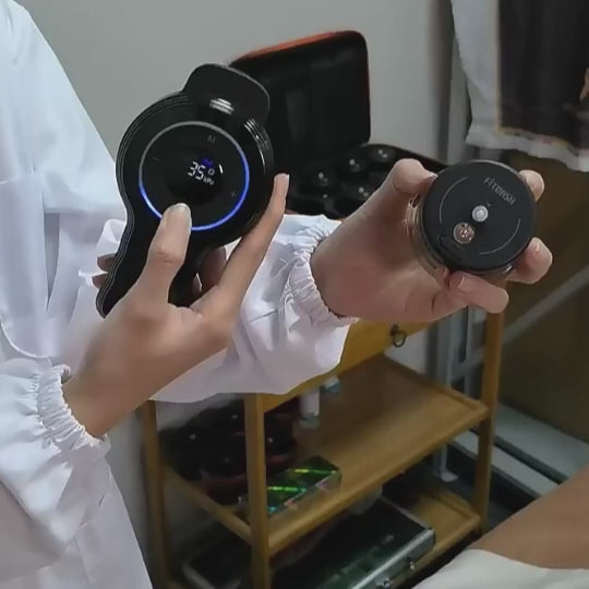 A person holding the Fitdash Multi-Cupping Device and a smaller cup, showcasing multi-cup cupping technology.